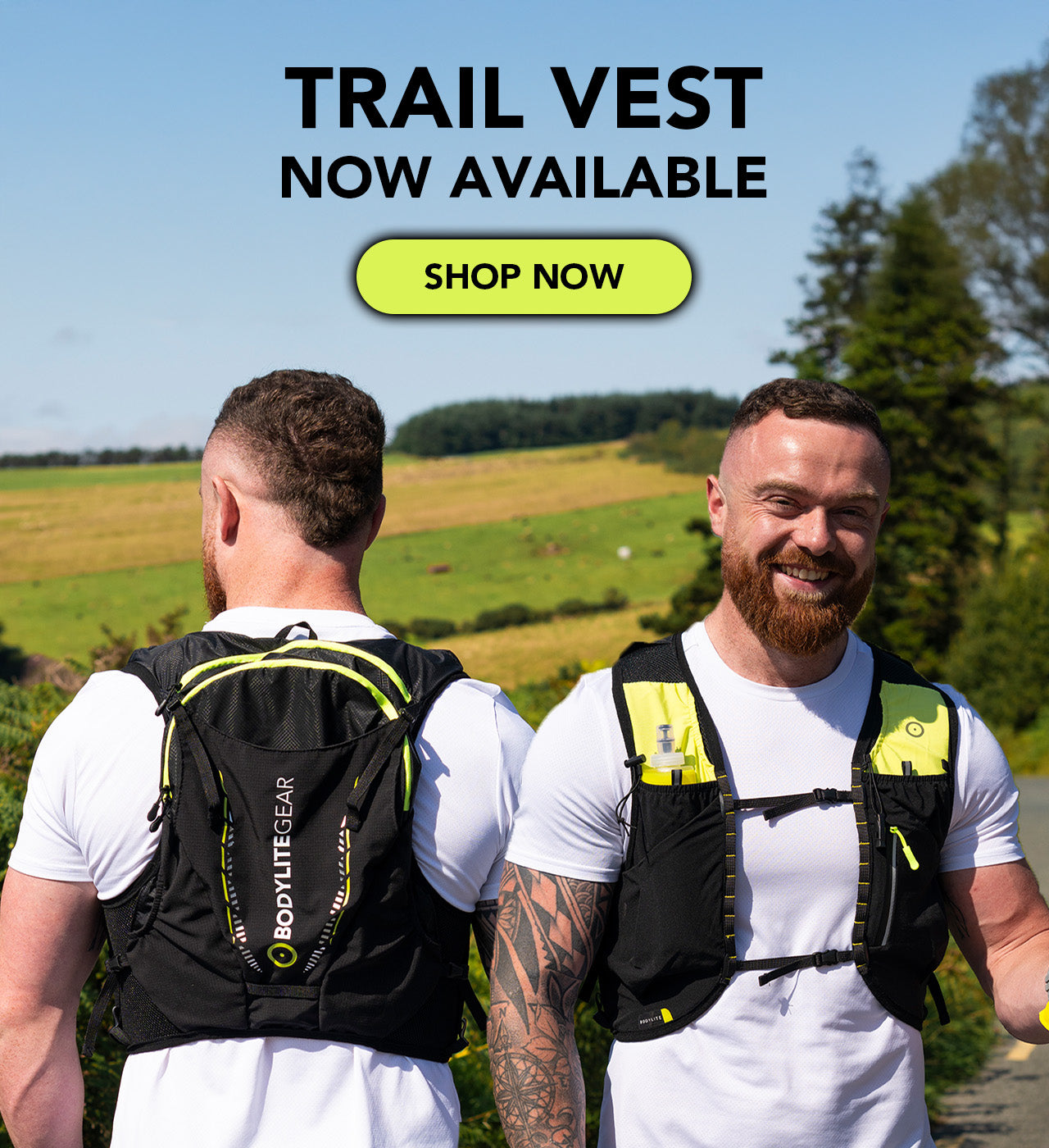 Two men wearing black trail vests with a scenic background and 'Trail Vest Now Available' text.