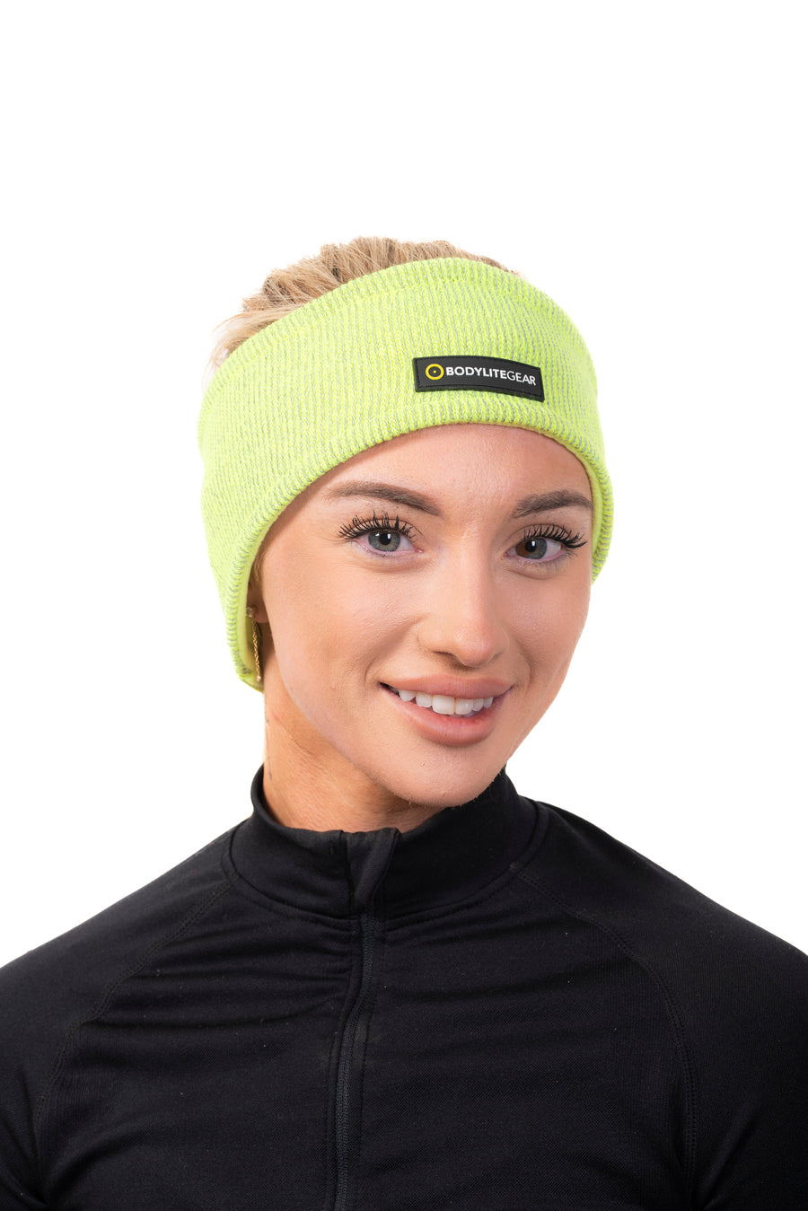 A woman wearing a reflective fleece lined headband in a neon yellow colour