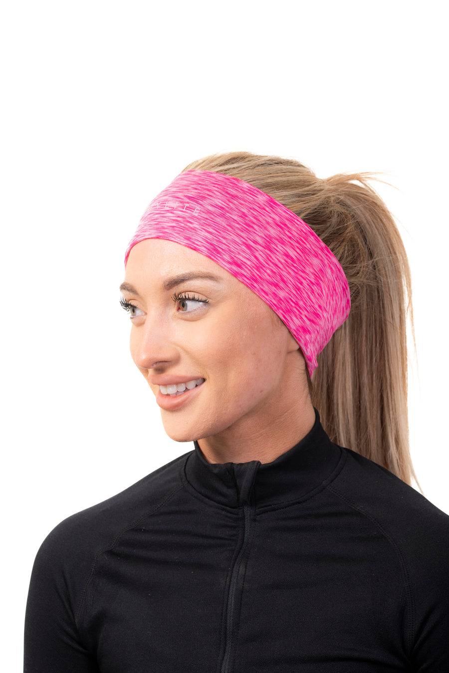 A woman wearing a pink and white speckled running headband with a small reflective logo, paired with a black active top.