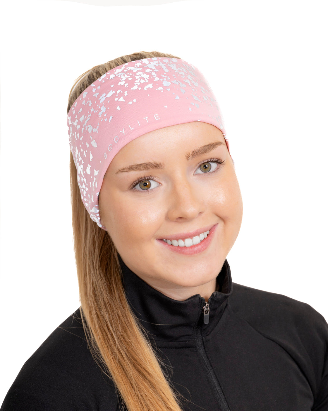 Woman wearing a pink headband with white patterns on a white background